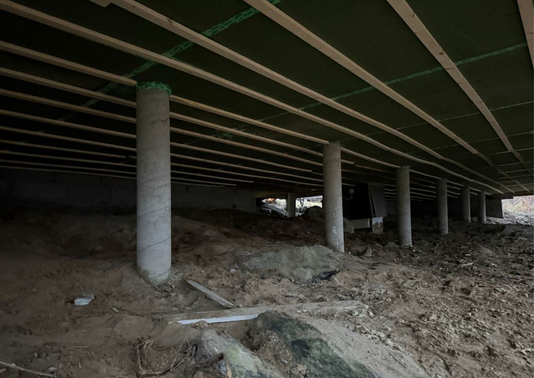 Ryömintätila, jossa betonipilarit ja palkisto kannattavat alapohjaa.